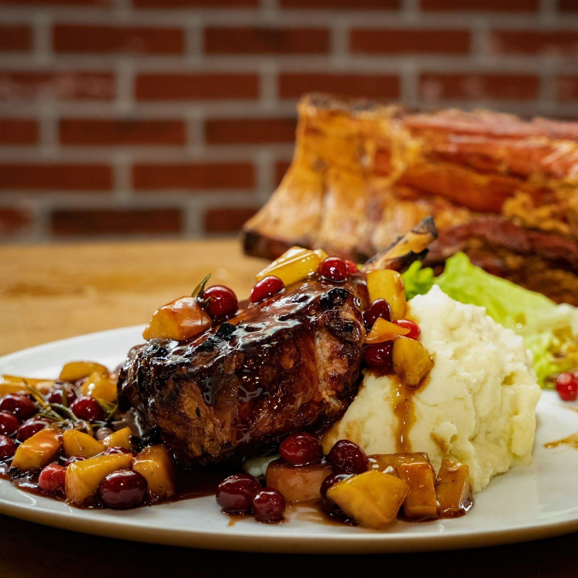 pork chop with mashed potato, topped with pineapple and cherries